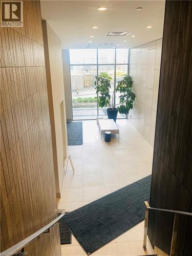 Modern entryway with expansive windows and light-colored tile flooring - 85 Duke Street W Unit# 507, Kitchener, ON - Indoor