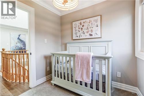 Carpeted room with crown molding, a decorative ceiling light fixture, and a window - 1264 Kane Road, Mississauga, ON - Indoor Photo Showing Bedroom