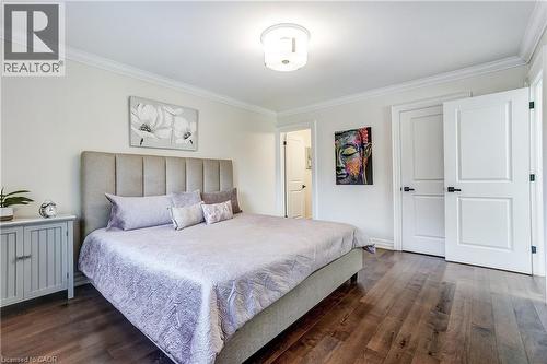 Spacious room featuring wood-finish flooring, white walls, and crown molding - 1264 Kane Road, Mississauga, ON - Indoor Photo Showing Bedroom