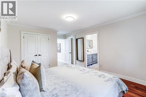 Hardwood flooring extends through the room, complemented by white crown molding and baseboards - 1264 Kane Road, Mississauga, ON - Indoor Photo Showing Bedroom