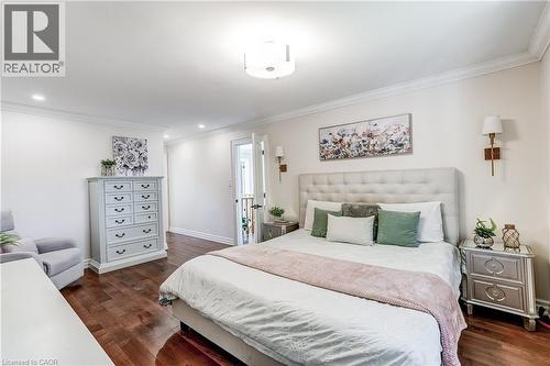 Spacious room featuring rich wood-finish flooring, recessed lighting, crown molding, and two wall-mounted sconces - 1264 Kane Road, Mississauga, ON - Indoor Photo Showing Bedroom