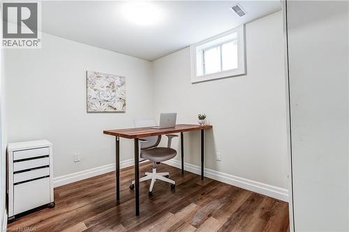 Bright room featuring wood-finish flooring, white baseboards, a high-set window, and a flush-mount ceiling light - 1264 Kane Road, Mississauga, ON - Indoor Photo Showing Office