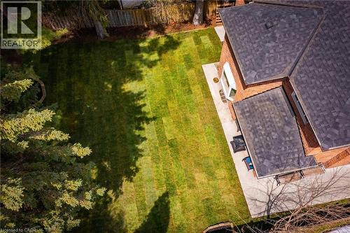 Expansive backyard featuring a manicured lawn, established perimeter fencing, and mature evergreen trees - 1264 Kane Road, Mississauga, ON - Outdoor With Deck Patio Veranda