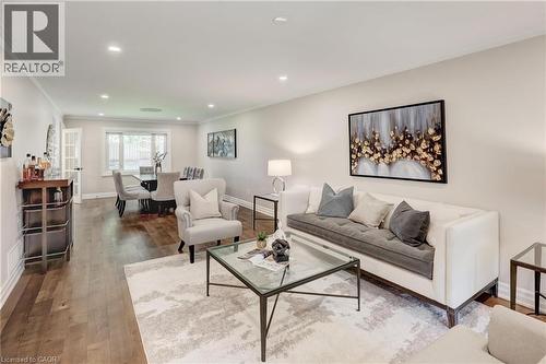 Open-concept living and dining areas featuring recessed lighting, crown molding, and wood-finish flooring - 1264 Kane Road, Mississauga, ON - Indoor Photo Showing Living Room