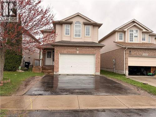 Two-story residence featuring a brick and siding exterior, an attached garage, and a paved driveway - 1126 Copper Leaf Crescent, Kitchener, ON - Outdoor