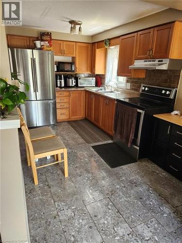 Kitchen featuring light wood cabinetry and a stainless steel refrigerator - 1126 Copper Leaf Crescent, Kitchener, ON - Indoor Photo Showing Kitchen