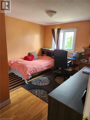 Bright room featuring wood-finish flooring and a white-framed window - 1126 Copper Leaf Crescent, Kitchener, ON - Indoor Photo Showing Bedroom