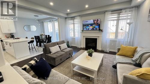Open Concept Family Dining and Kitchen - 325 Trudeau Drive E, Milton, ON - Indoor Photo Showing Living Room With Fireplace