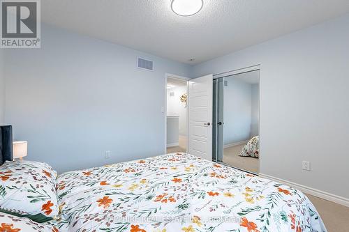 Bedroom 2 with Mirrored Closet - 325 Trudeau Drive E, Milton, ON - Indoor Photo Showing Bedroom