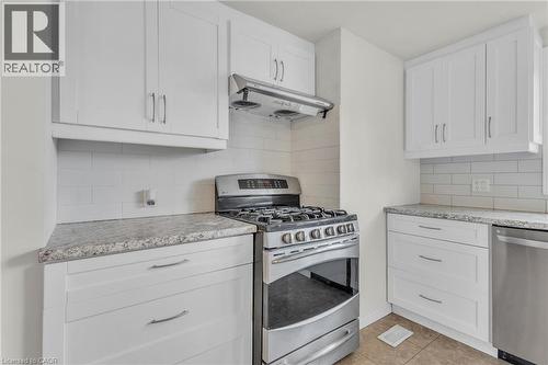 Kitchen featuring stainless steel range, matching range hood, and a built-in dishwasher - 22 Blackhorne Crescent, Kitchener, ON - Indoor Photo Showing Kitchen