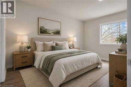 Spacious room featuring wood-finish flooring, light neutral wall tones, and a large window - 22 Blackhorne Crescent, Kitchener, ON - Indoor Photo Showing Bedroom