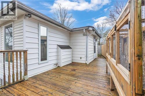Expansive wood-finish deck with a wood railing and white horizontal siding - 22 Blackhorne Crescent, Kitchener, ON - Outdoor With Exterior