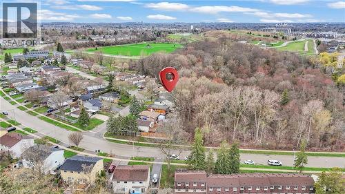 Aerial perspective showcasing a residential area with a prominent wooded landscape - 22 Blackhorne Crescent, Kitchener, ON - Outdoor With View