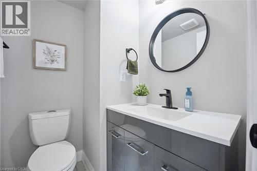 Powder room featuring a sleek gray vanity with a white countertop and integrated sink - 5449 Rochelle Way, Mississauga, ON - Indoor Photo Showing Bathroom