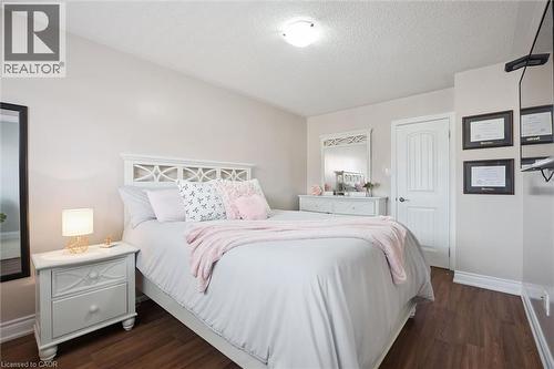 Bedroom featuring wood-finish flooring, light-toned walls, and a white paneled door - 5449 Rochelle Way, Mississauga, ON - Indoor Photo Showing Bedroom