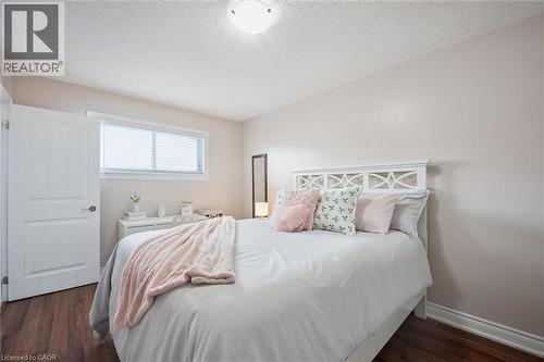 Bedroom featuring wood-finish flooring, a white trim window with blinds, and light-toned walls - 5449 Rochelle Way, Mississauga, ON - Indoor Photo Showing Bedroom