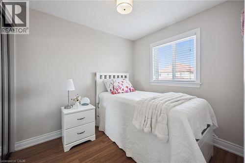 Bright room with wood-finish flooring, a double-paned window, and a built-in closet with sliding doors - 5449 Rochelle Way, Mississauga, ON - Indoor Photo Showing Bedroom