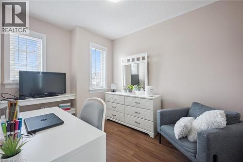 Room featuring wood-finish flooring, two windows with white blinds, and light-toned wall paint - 5449 Rochelle Way, Mississauga, ON - Indoor
