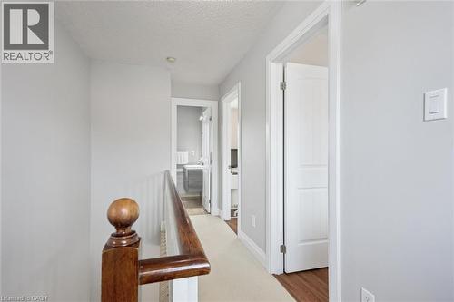 Upper-level hallway featuring a wood-finish handrail, light wall paint, and white trim - 5449 Rochelle Way, Mississauga, ON - Indoor Photo Showing Other Room
