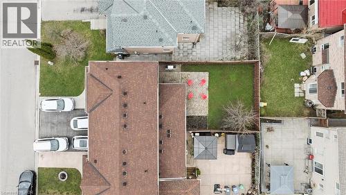 Expansive backyard featuring a manicured lawn, paved patio area, and mature trees - 5449 Rochelle Way, Mississauga, ON - Outdoor