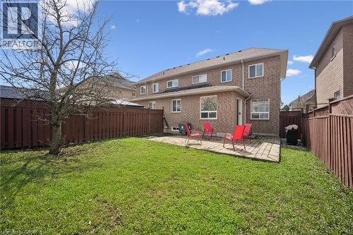 Expansive backyard featuring a lush lawn, a mature tree, and a stone paver patio - 5449 Rochelle Way, Mississauga, ON - Outdoor