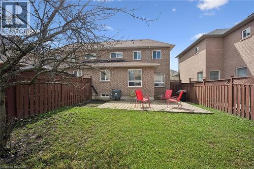 Expansive backyard featuring a manicured lawn, brick paver patio, and full perimeter wood fencing with lattice accents - 5449 Rochelle Way, Mississauga, ON - Outdoor
