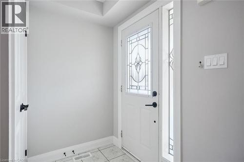 Entryway featuring a white door with decorative glass inserts and a sidelight, complementing the neutral wall tones - 5449 Rochelle Way, Mississauga, ON - Indoor Photo Showing Other Room