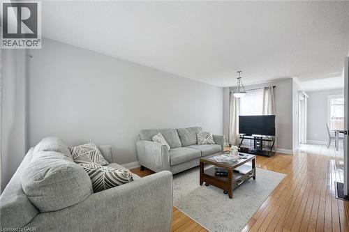 Living room featuring hardwood flooring, light gray wall paint, and a pendant light fixture - 5449 Rochelle Way, Mississauga, ON - Indoor Photo Showing Living Room