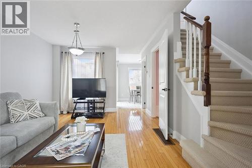 Living area featuring wood-finish flooring, a contemporary ceiling fixture, and a window with sheer drapes - 5449 Rochelle Way, Mississauga, ON - Indoor Photo Showing Other Room
