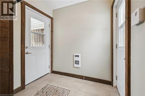 Entryway featuring a white paneled door with integrated window and rustic wood-finish trim - 838 Moore Street, Cambridge, ON - Indoor Photo Showing Other Room