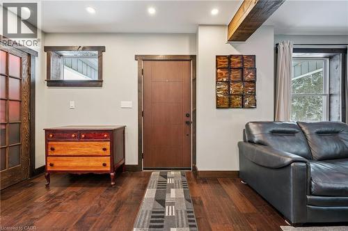 Rich wood-finish flooring complements the solid wood entry door - 838 Moore Street, Cambridge, ON - Indoor Photo Showing Other Room