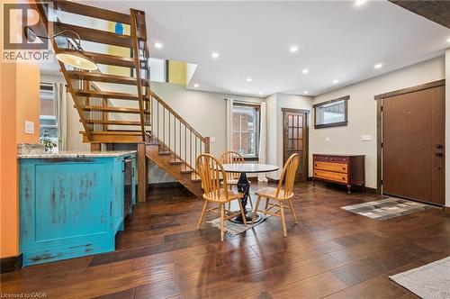 Rich wood-finish flooring complements the open-tread staircase with metal balusters - 838 Moore Street, Cambridge, ON - Indoor