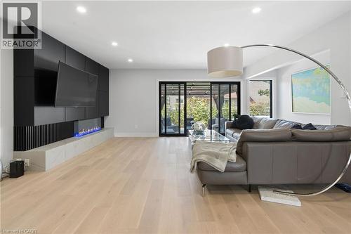 Living room featuring recessed lighting, light wood-style floors, and a tile fireplace - 17 Clearview Drive, Hamilton, ON - Indoor
