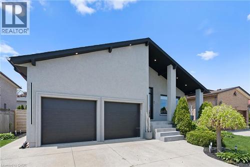 Contemporary exterior with a prominent A-frame roofline and light stucco finish - 17 Clearview Drive, Hamilton, ON - Outdoor