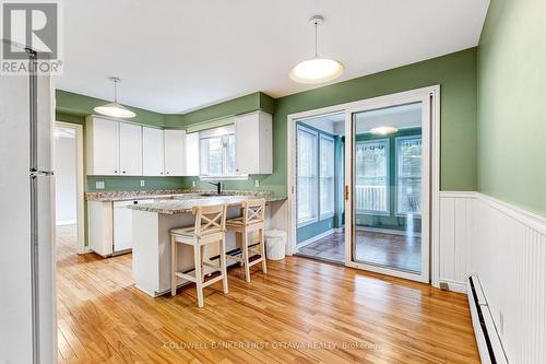 Breakfast bar & dinette with patio door to sunroom - 12 Glenview Crescent, Perth, ON - Indoor