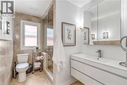 Contemporary bathroom featuring a floating vanity with integrated sink, a mirrored medicine cabinet, and a glass-enclosed shower - 2123 Deyncourt Drive, Burlington, ON - Indoor Photo Showing Bathroom
