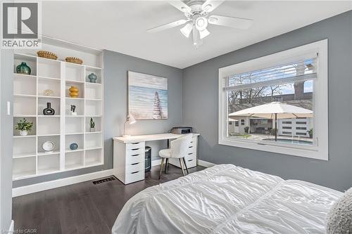 Spacious room featuring dark wood-finish flooring, a ceiling fan, and built-in shelving - 2123 Deyncourt Drive, Burlington, ON - Indoor Photo Showing Bedroom