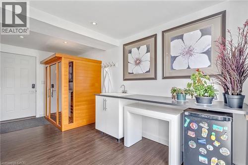 Interior space featuring wood-finish flooring and a built-in sauna with glass and wood paneling - 2123 Deyncourt Drive, Burlington, ON - Indoor Photo Showing Other Room