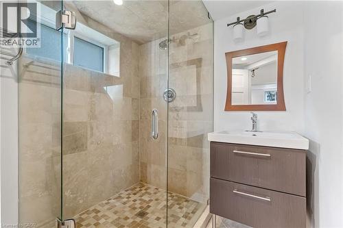 Contemporary bathroom featuring a glass-enclosed shower with large format wall tiles and mosaic floor tiles - 2123 Deyncourt Drive, Burlington, ON - Indoor Photo Showing Bathroom