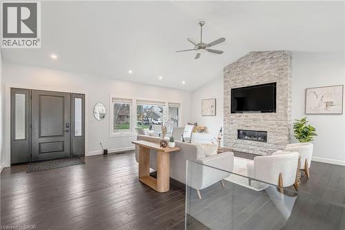 Spacious living area featuring wood-finish flooring, a vaulted ceiling, and recessed lighting - 2123 Deyncourt Drive, Burlington, ON - Indoor Photo Showing Living Room With Fireplace