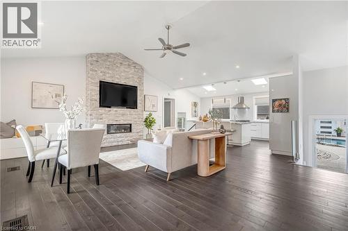 Open-concept living area with dark wood-finish flooring, a vaulted ceiling, and recessed lighting - 2123 Deyncourt Drive, Burlington, ON - Indoor Photo Showing Living Room With Fireplace