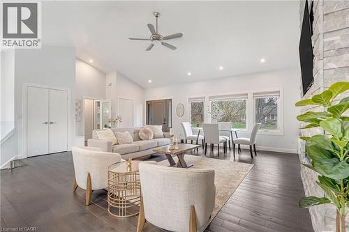 Spacious living area featuring dark wood-finish flooring and a stone accent wall - 2123 Deyncourt Drive, Burlington, ON - Indoor Photo Showing Living Room