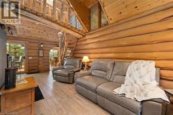 Expansive log cabin interior featuring natural wood walls and ceilings - 