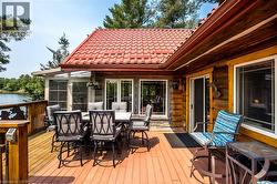 Expansive outdoor deck featuring composite decking and a wood railing with decorative metal inserts - 