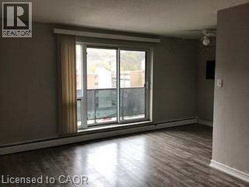sliding glass door opening to a private balcony - 81 E Charlton Avenue E Unit# 904, Hamilton, ON - Indoor Photo Showing Other Room