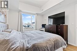 Bedroom featuring light wood-style floors and baseboards - 