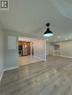 Unfurnished living room with light wood-type flooring and recessed lighting - 