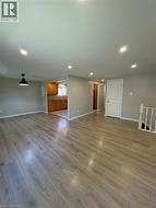 Unfurnished living room with light wood-style flooring and recessed lighting - 