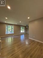Unfurnished room featuring light wood finished floors and recessed lighting - 