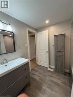 Full bath featuring a shower with curtain, vanity, dark wood-style floors, a bathtub, and recessed lighting - 